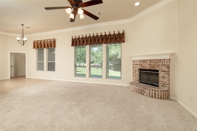 unfurnished living room with carpet flooring, ceiling fan with notable chandelier, crown molding, and a brick fireplace