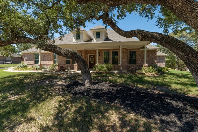 view of front of home with brick siding and a front lawn