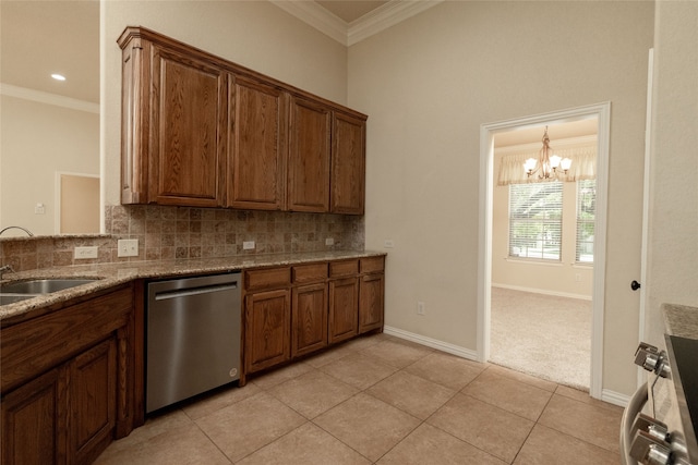 kitchen featuring light stone countertops, a notable chandelier, stainless steel appliances, ornamental molding, and decorative backsplash