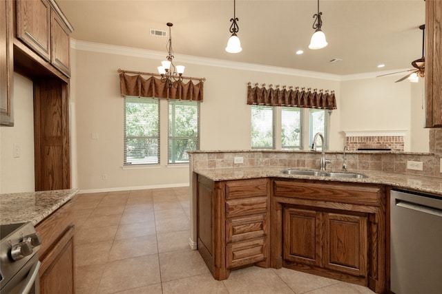 kitchen with ceiling fan with notable chandelier, stainless steel appliances, light stone counters, sink, and decorative backsplash