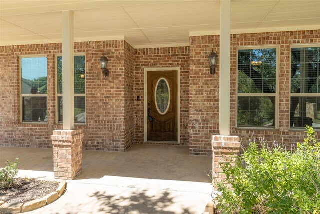 view of exterior entry with a porch