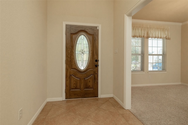 carpeted entryway featuring crown molding