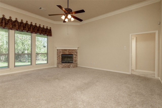 unfurnished living room featuring crown molding, light carpet, a brick fireplace, and ceiling fan