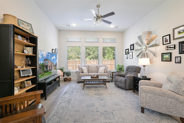 living room featuring hardwood / wood-style flooring and ceiling fan