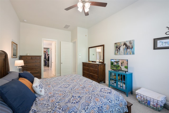 bedroom with carpet, ceiling fan, a walk in closet, and a closet