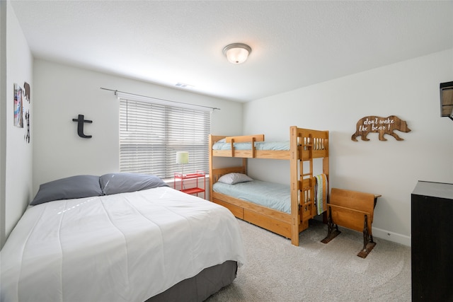 carpeted bedroom with a textured ceiling