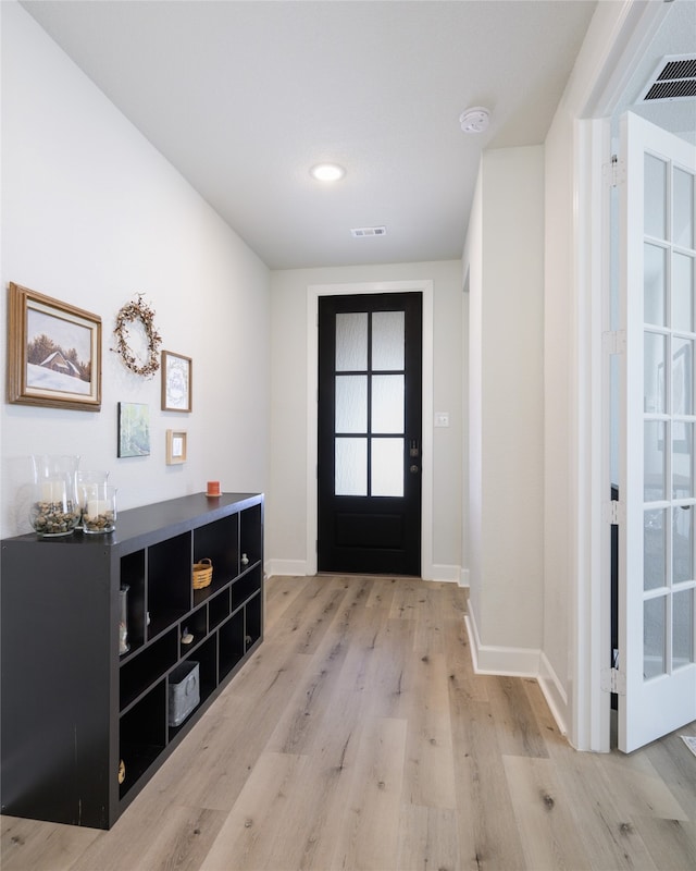 doorway with light hardwood / wood-style floors