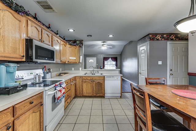 kitchen featuring sink, lofted ceiling, hanging light fixtures, white appliances, and ceiling fan