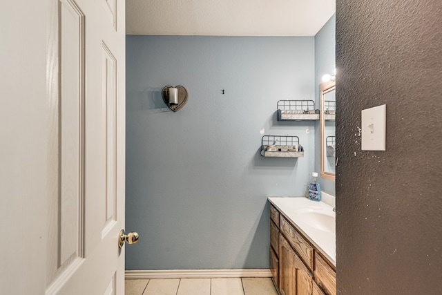 bathroom with tile patterned floors and vanity