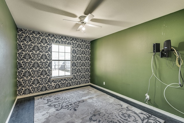 spare room with ceiling fan and a textured ceiling