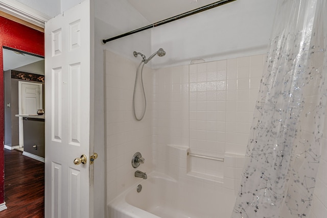 bathroom featuring hardwood / wood-style floors and shower / bath combo