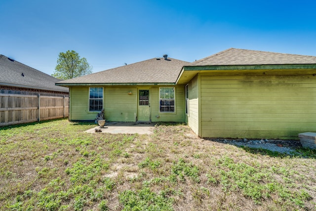 back of property featuring a yard and a patio area