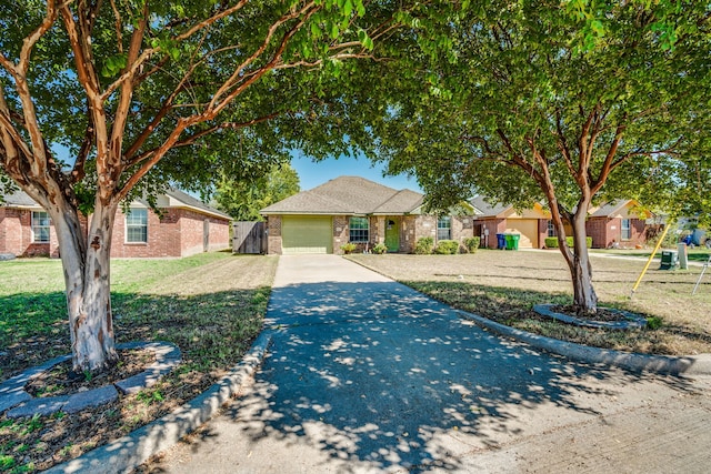 view of front of property featuring a garage and a front lawn