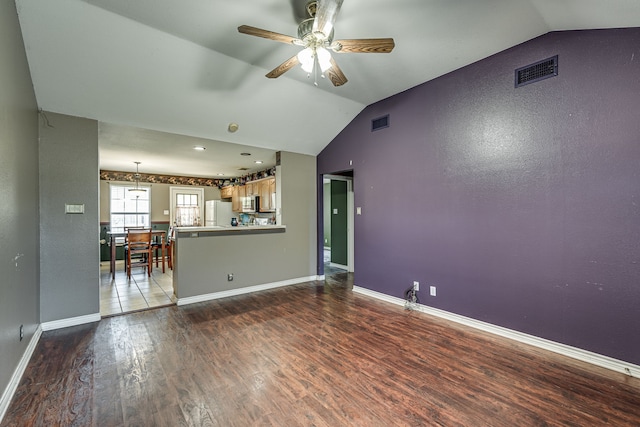 unfurnished living room featuring ceiling fan, hardwood / wood-style flooring, and lofted ceiling