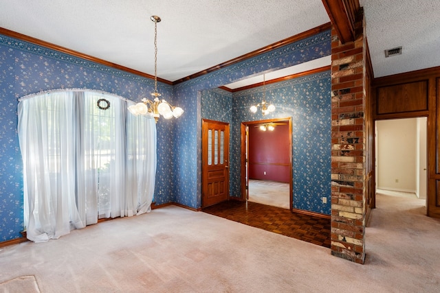 unfurnished dining area featuring dark carpet, ornamental molding, a chandelier, and a textured ceiling