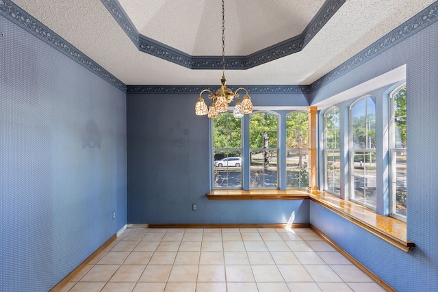 interior space with a tray ceiling, a textured ceiling, and an inviting chandelier