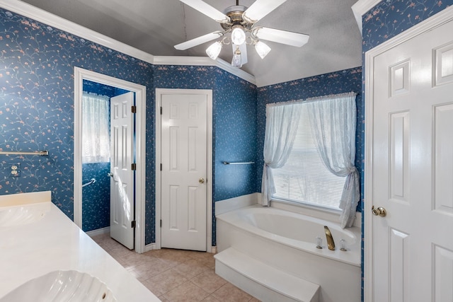 bathroom featuring tile patterned floors, ornamental molding, a washtub, ceiling fan, and lofted ceiling