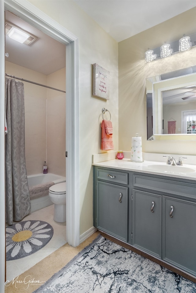 full bathroom with vanity, toilet, ceiling fan, and shower / bath combo with shower curtain