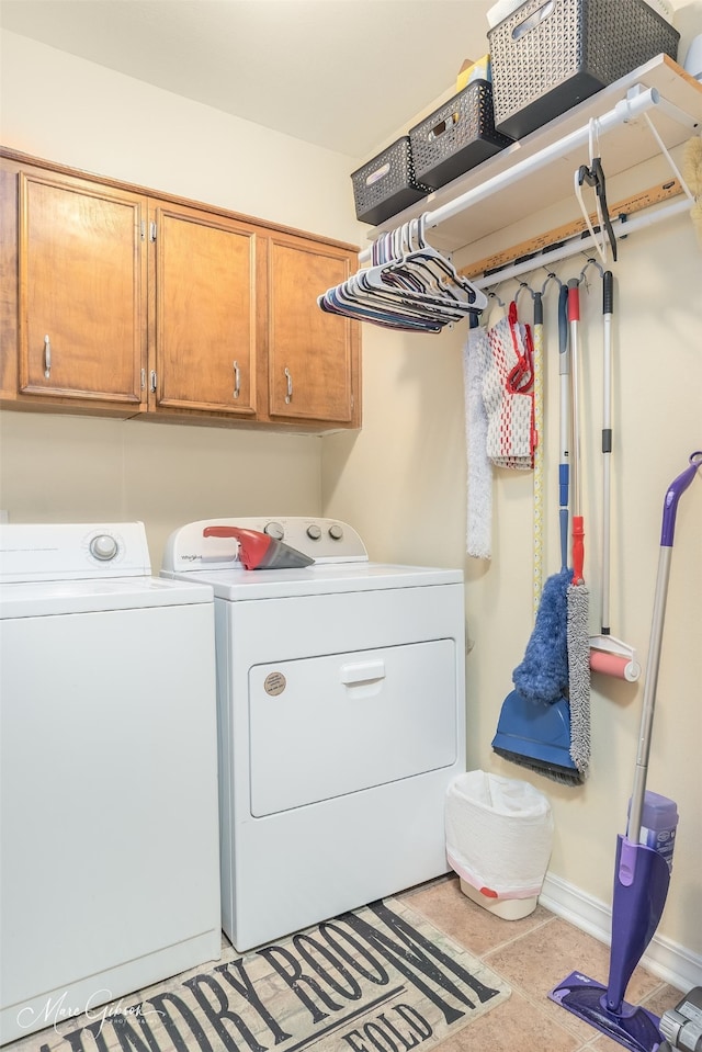 laundry room with cabinets and washing machine and clothes dryer