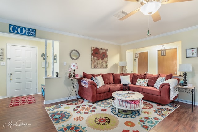 living room with crown molding, wood-type flooring, and ceiling fan