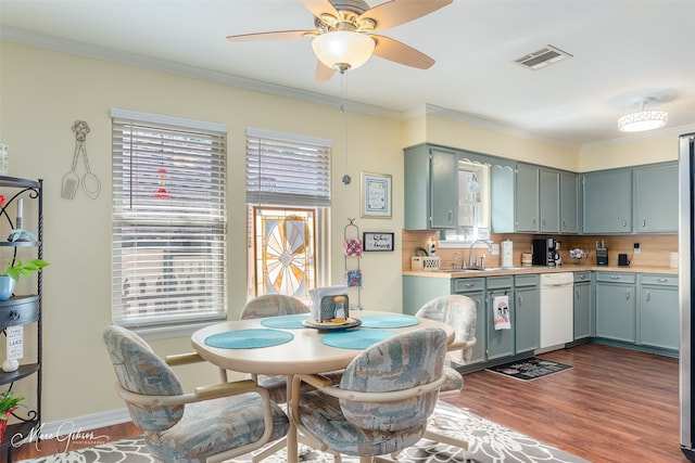 kitchen with a wealth of natural light, ceiling fan, dark hardwood / wood-style flooring, and tasteful backsplash