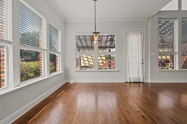 unfurnished dining area featuring ornamental molding, dark hardwood / wood-style flooring, and a wealth of natural light