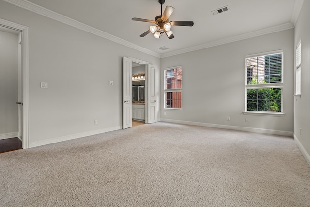 carpeted empty room featuring ceiling fan and crown molding