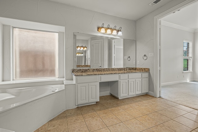 bathroom featuring ornamental molding, vanity, a bathing tub, and tile patterned floors