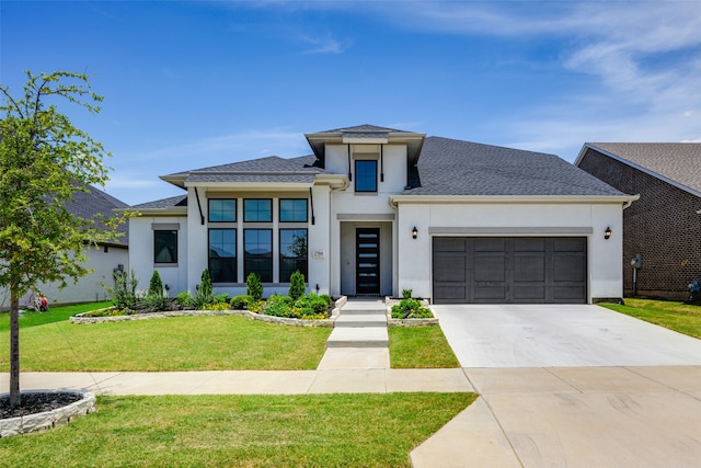 view of front of house featuring a garage and a front lawn