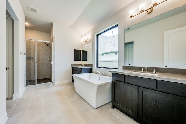 bathroom with tile patterned floors, vanity, and independent shower and bath