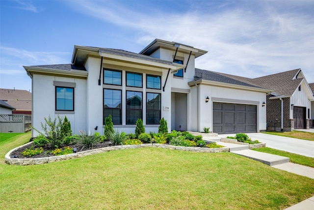 view of front facade with a front yard and a garage