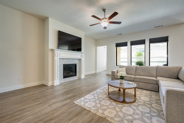 living room featuring wood-type flooring and ceiling fan