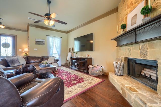 living room with ceiling fan, a fireplace, dark wood-type flooring, and crown molding