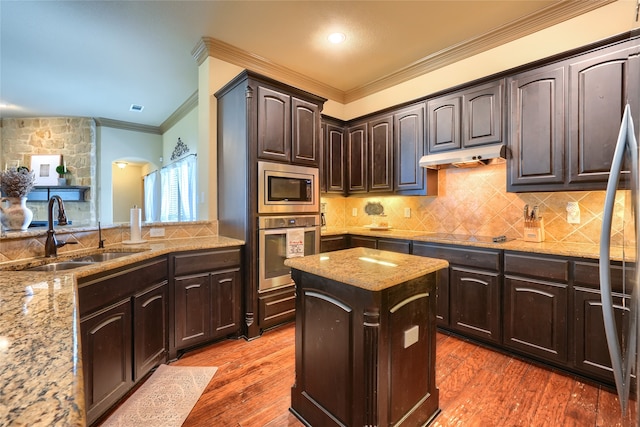 kitchen featuring light stone countertops, sink, appliances with stainless steel finishes, and dark hardwood / wood-style flooring