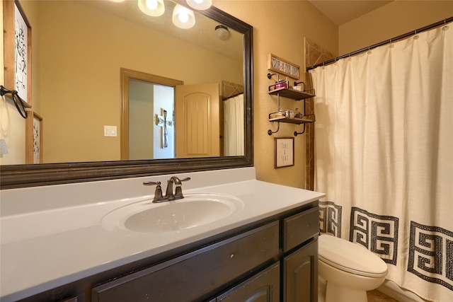 bathroom featuring toilet and vanity