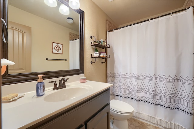 bathroom with toilet, vanity, and walk in shower