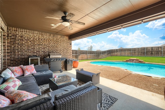 view of pool with grilling area, ceiling fan, a patio area, and an outdoor living space