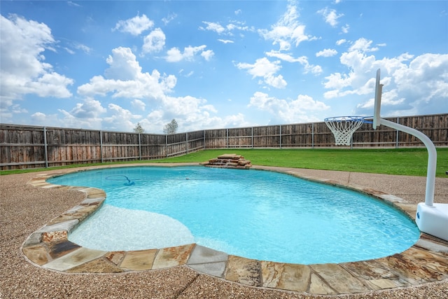 view of pool with a lawn