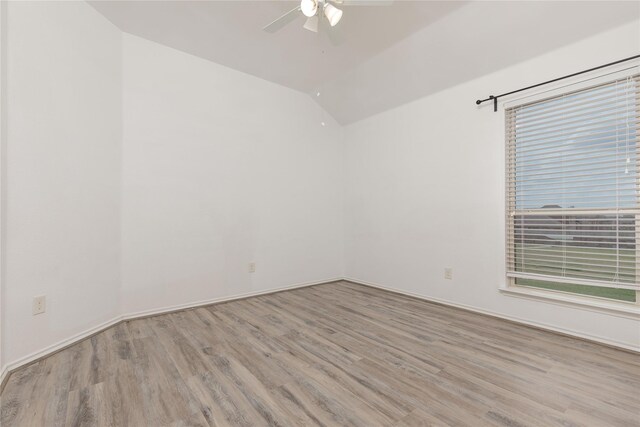 unfurnished room featuring ceiling fan, light hardwood / wood-style floors, and vaulted ceiling