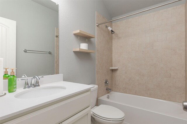 full bathroom featuring vanity, toilet, and tiled shower / bath combo