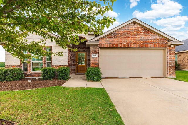 view of front of home featuring a garage and a front lawn