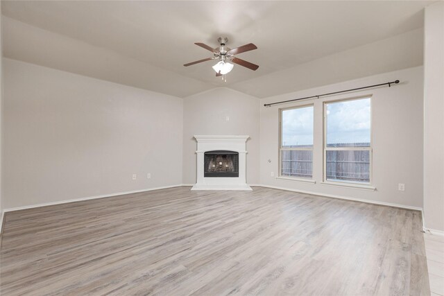 unfurnished living room featuring lofted ceiling, ceiling fan, and light hardwood / wood-style floors