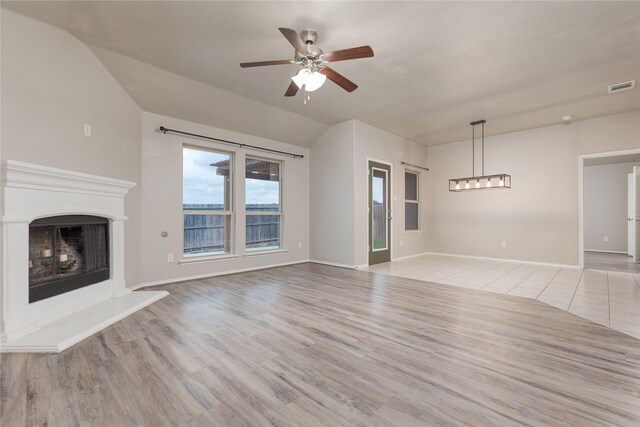 unfurnished living room with light hardwood / wood-style flooring and ceiling fan