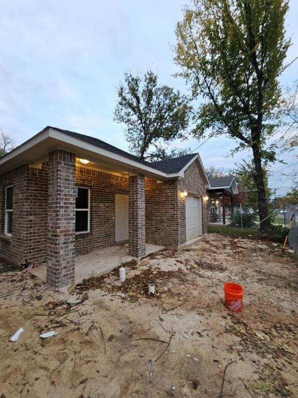 view of side of home featuring a garage