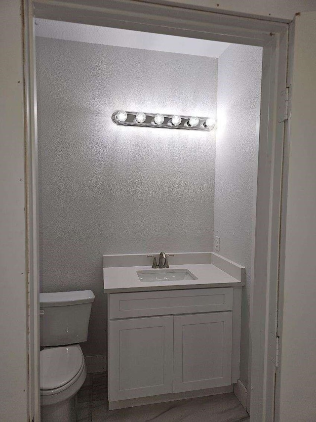 bathroom with toilet and vanity