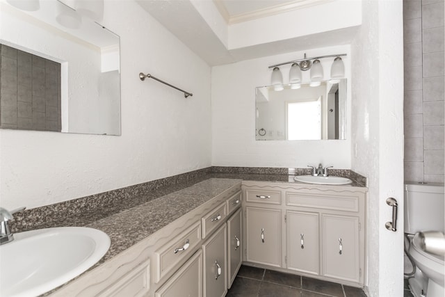 bathroom with ornamental molding, vanity, toilet, and tile patterned flooring