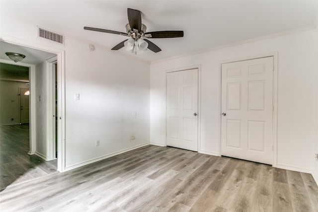 unfurnished bedroom with ceiling fan, ornamental molding, and light hardwood / wood-style floors