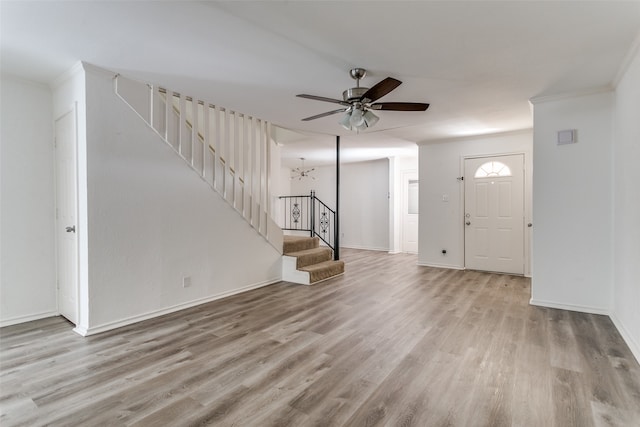 foyer entrance featuring ornamental molding, ceiling fan, and light hardwood / wood-style floors