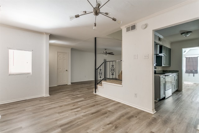 empty room with ornamental molding, wood-type flooring, and ceiling fan