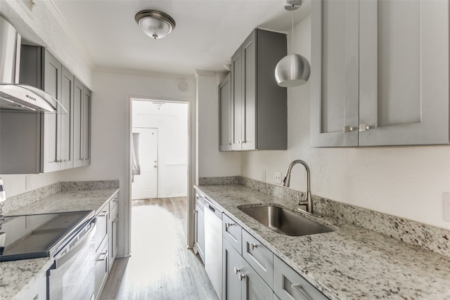 kitchen featuring light hardwood / wood-style floors, stainless steel appliances, light stone counters, sink, and wall chimney range hood